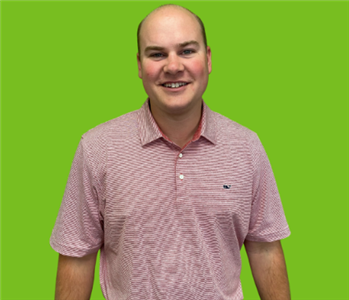 Bald male employee on green background 