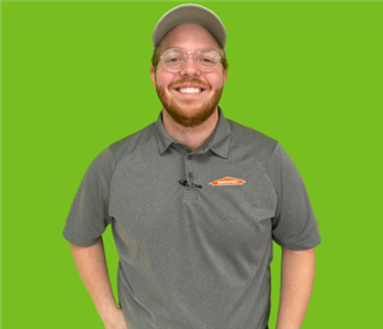 Male SERVPRO employee on green background