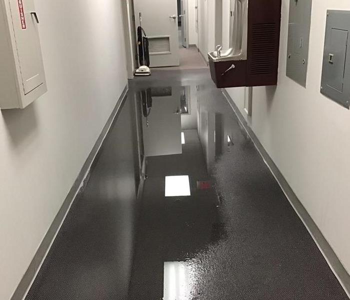 commercial building with standing water in the hallway